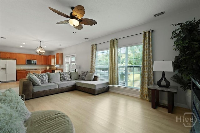 130 Willow Point Cir, Savannah, GA 31407 - living room with light wood finished floors, a chandelier, a ceiling fan, baseboards, and recessed lighting