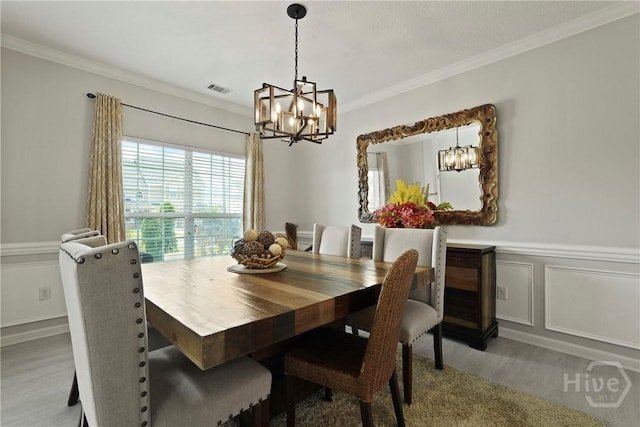 130 Willow Point Cir, Savannah, GA 31407 - dining space with a chandelier, wood finished floors, ornamental molding, and a wainscoted wall