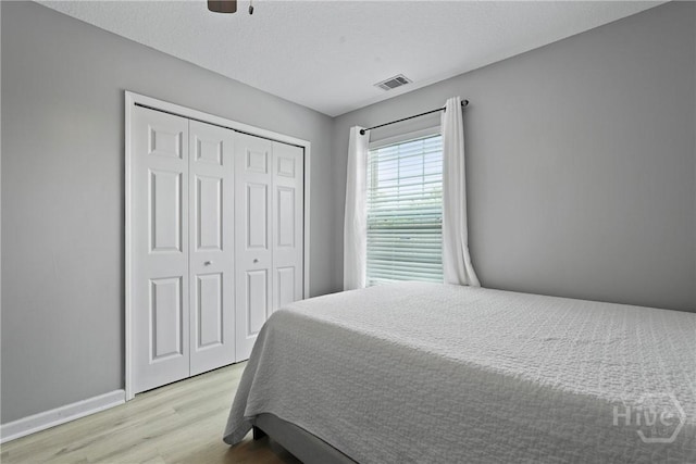 130 Willow Point Cir, Savannah, GA 31407 - bedroom featuring light wood-type flooring, a closet, ceiling fan, and baseboards