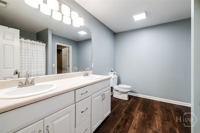 131 Warner Dr, Guyton, GA 31312 - full bath featuring double vanity, toilet, wood finished floors, and baseboards