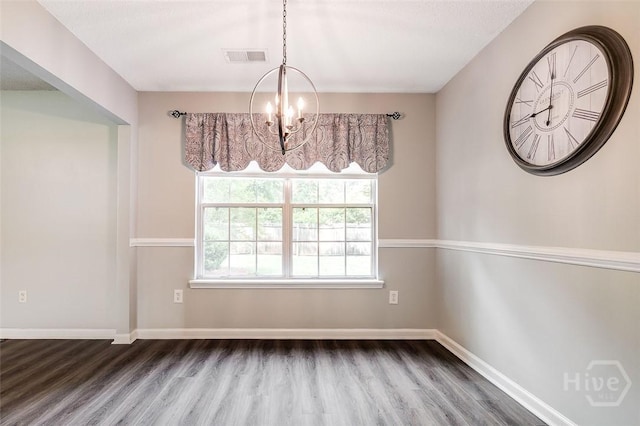 131 Warner Dr, Guyton, GA 31312 - unfurnished dining area featuring a chandelier, dark wood-type flooring, and baseboards