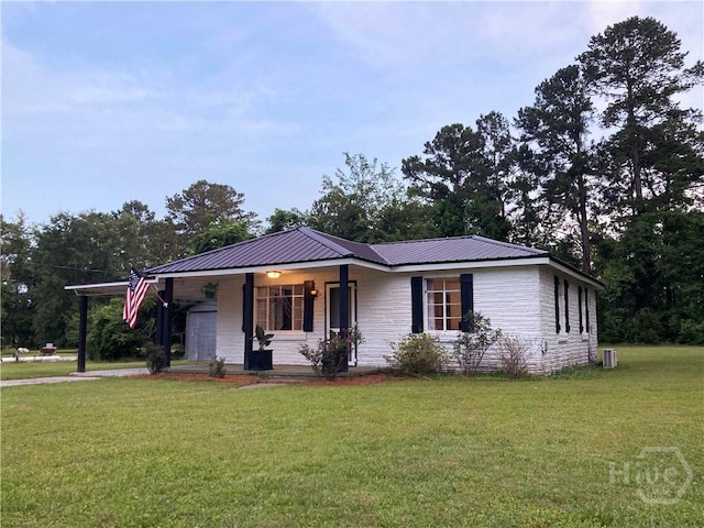 155 Oak Hill Rd, Richmond Hill, GA 31324 - ranch-style house with covered porch, a front lawn, metal roof, and an attached carport