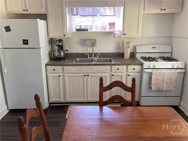 155 Oak Hill Rd, Richmond Hill, GA 31324 - kitchen with white appliances, a sink, dark countertops, and dark wood finished floors