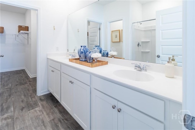 135 Crimson Ln, Savannah, GA 31302 - bathroom with double vanity, wood finished floors, a shower, and a walk in closet