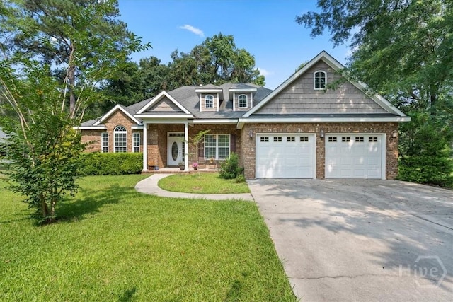 190 Sandpiper Dr, Midway, GA 31320 - view of front of house with an attached garage, driveway, a front lawn, brick siding, and covered porch