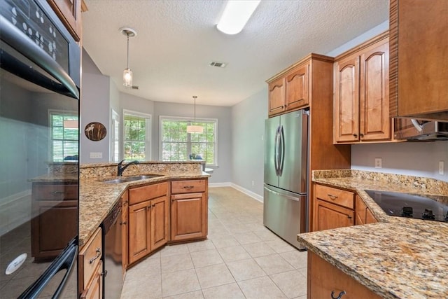 190 Sandpiper Dr, Midway, GA 31320 - kitchen featuring black appliances, a sink, light stone countertops, brown cabinets, and light tile patterned floors
