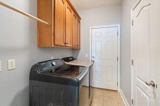 190 Sandpiper Dr, Midway, GA 31320 - laundry room with separate washer and dryer, cabinet space, light tile patterned floors, and baseboards