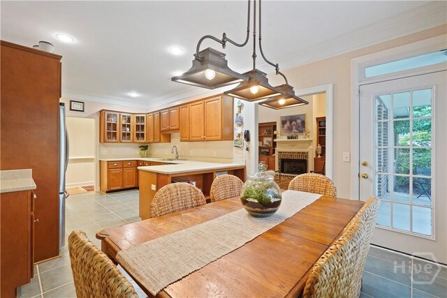 118 Woodline Dr, Savannah, GA 31410 - dining space featuring light tile patterned floors, crown molding, a fireplace, and recessed lighting
