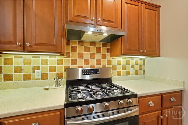 118 Woodline Dr, Savannah, GA 31410 - kitchen featuring gas range, under cabinet range hood, light countertops, tasteful backsplash, and brown cabinetry