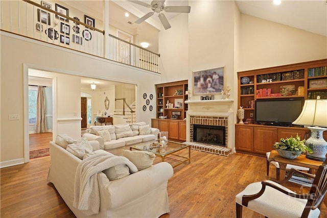 118 Woodline Dr, Savannah, GA 31410 - living room with high vaulted ceiling, stairs, a ceiling fan, wood finished floors, and a fireplace