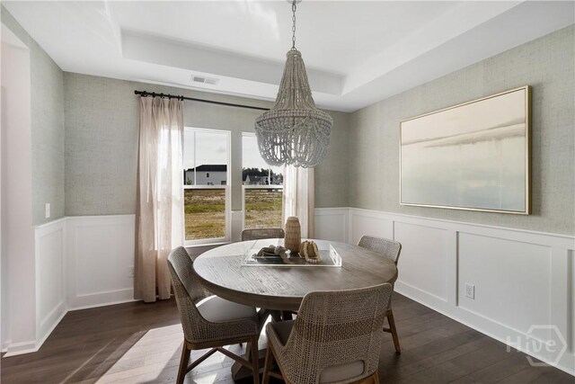 797 Blue Moon Xing, Pooler, GA 31322 - dining room featuring dark wood finished floors, a chandelier, wallpapered walls, a wainscoted wall, and a raised ceiling