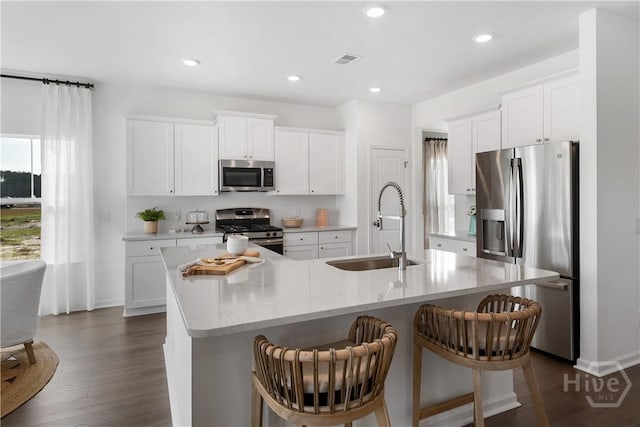 797 Blue Moon Xing, Pooler, GA 31322 - kitchen featuring appliances with stainless steel finishes, a sink, an island with sink, white cabinets, and recessed lighting