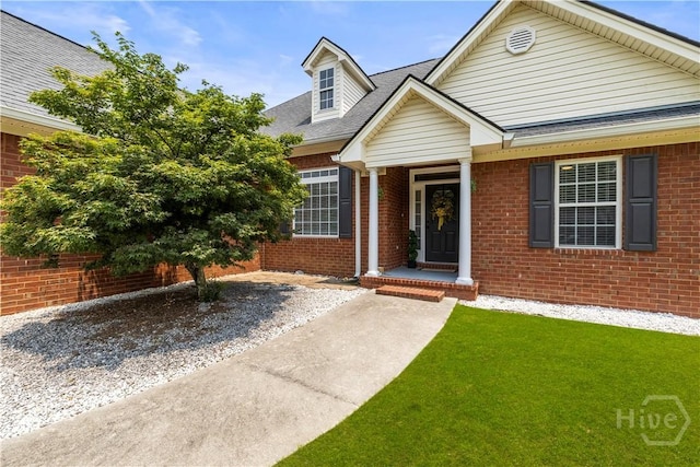 325 Flat Bush Dr, Guyton, GA 31312 - view of front of house featuring brick siding, roof with shingles, and a front lawn