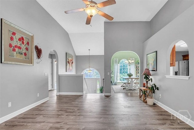 207 Pink Dogwood Ln, Pooler, GA 31322 - living area featuring arched walkways, high vaulted ceiling, wood finished floors, a ceiling fan, and baseboards