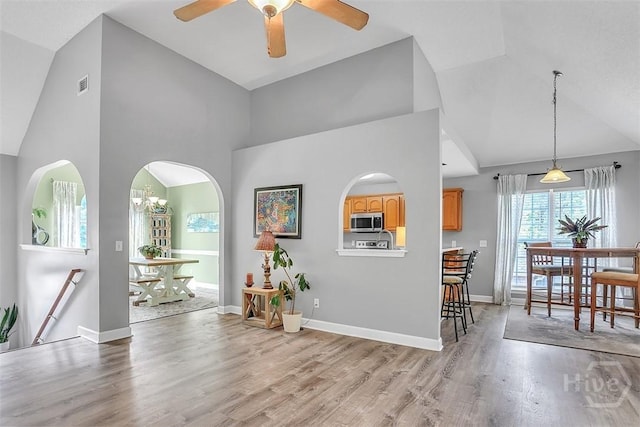 207 Pink Dogwood Ln, Pooler, GA 31322 - entrance foyer featuring high vaulted ceiling, light wood-style flooring, a ceiling fan, arched walkways, and baseboards