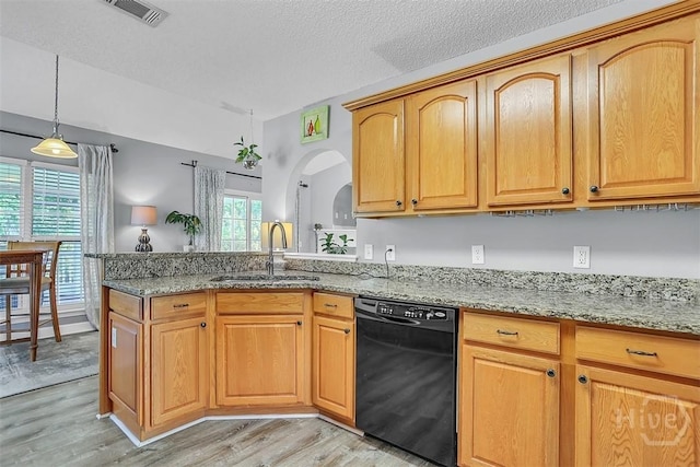 207 Pink Dogwood Ln, Pooler, GA 31322 - kitchen featuring black dishwasher, a sink, arched walkways, light wood-type flooring, and light stone countertops