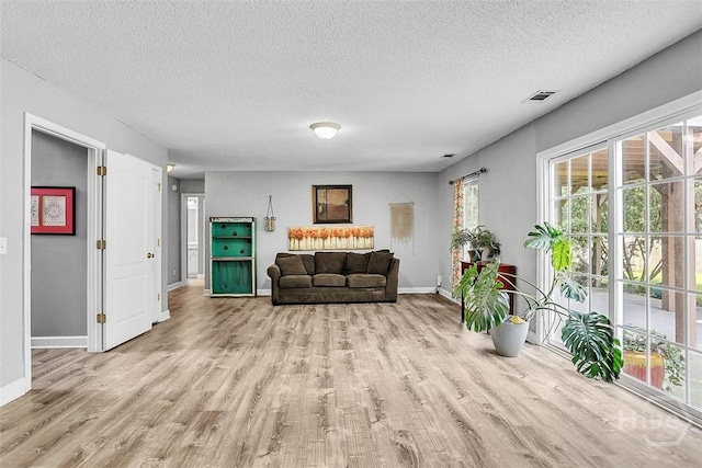 207 Pink Dogwood Ln, Pooler, GA 31322 - living area with wood finished floors, baseboards, and a textured ceiling