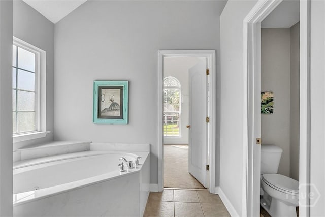 207 Pink Dogwood Ln, Pooler, GA 31322 - bathroom with a garden tub, toilet, tile patterned floors, and baseboards