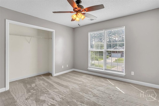 207 Pink Dogwood Ln, Pooler, GA 31322 - unfurnished bedroom with carpet, baseboards, a closet, a textured ceiling, and a ceiling fan