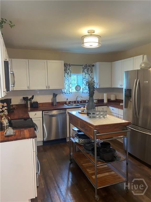 4114 Old Louisville Rd, Garden City, GA 31408 - kitchen with stainless steel appliances, a sink, white cabinetry, and wood counters