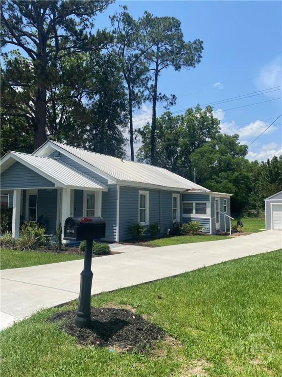 4114 Old Louisville Rd, Garden City, GA 31408 - ranch-style home featuring a front yard, metal roof, and driveway