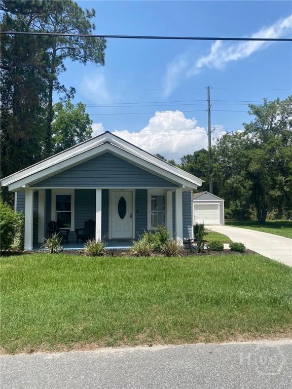 4114 Old Louisville Rd, Garden City, GA 31408 - view of front of property featuring a porch, a front yard, and an outbuilding