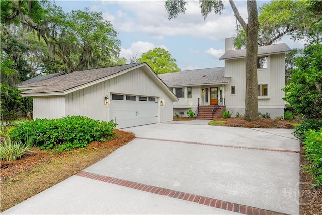 6 Schroeder Ct, Savannah, GA 31411 - view of front of home featuring a shingled roof, driveway, an attached garage, and a chimney