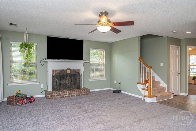 92 Shady Hill Cir, Richmond Hill, GA 31324 - unfurnished living room with carpet flooring, a ceiling fan, stairs, a textured ceiling, and baseboards