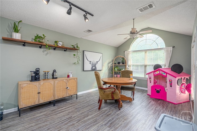 92 Shady Hill Cir, Richmond Hill, GA 31324 - dining room with wood finished floors, ceiling fan, baseboards, lofted ceiling, and a textured ceiling