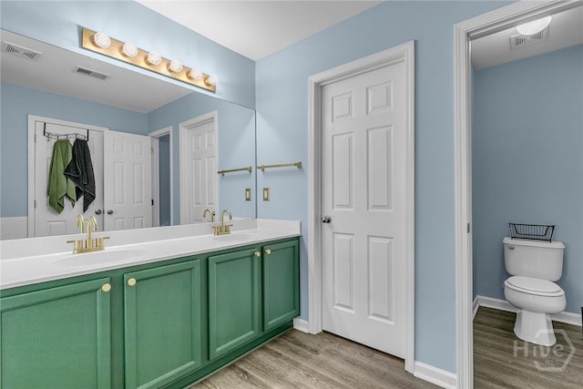 2 Timber Crest Ct, Savannah, GA 31407 - full bathroom with wood finished floors, double vanity, toilet, and baseboards