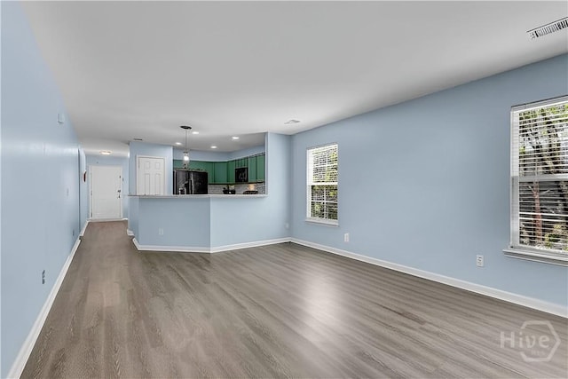 2 Timber Crest Ct, Savannah, GA 31407 - unfurnished living room featuring dark wood-style floors, baseboards, healthy amount of natural light, and recessed lighting