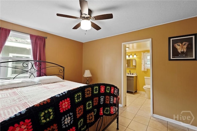 26 Arthur Cir, Savannah, GA 31406 - bedroom featuring baseboards, light tile patterned floors, ensuite bathroom, and ceiling fan
