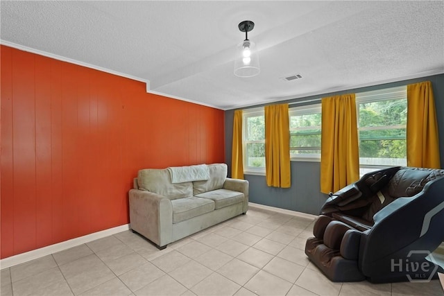 26 Arthur Cir, Savannah, GA 31406 - living area with healthy amount of natural light, a textured ceiling, baseboards, and light tile patterned floors