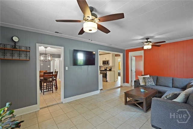 26 Arthur Cir, Savannah, GA 31406 - living room featuring light tile patterned floors, a ceiling fan, ornamental molding, baseboards, and wooden walls