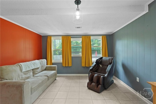 26 Arthur Cir, Savannah, GA 31406 - living area featuring a textured ceiling, ornamental molding, light tile patterned floors, wood walls, and baseboards