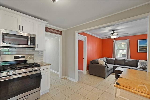 26 Arthur Cir, Savannah, GA 31406 - kitchen featuring stainless steel appliances, tasteful backsplash, white cabinets, light tile patterned floors, and a ceiling fan