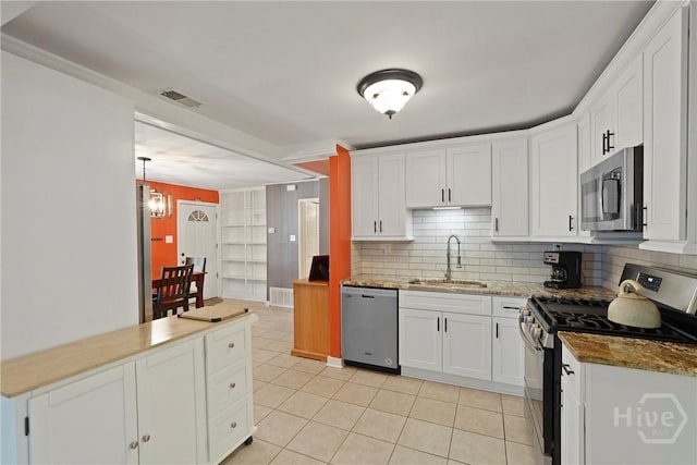 26 Arthur Cir, Savannah, GA 31406 - kitchen featuring appliances with stainless steel finishes, a sink, light tile patterned floors, and white cabinetry