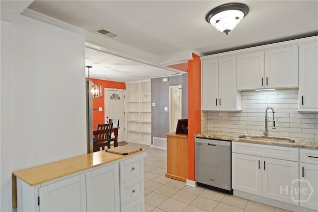26 Arthur Cir, Savannah, GA 31406 - kitchen featuring stainless steel dishwasher, a sink, white cabinets, backsplash, and light tile patterned floors