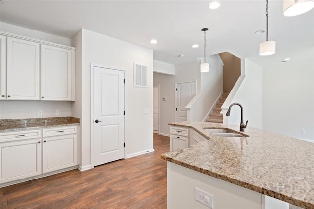 303 Waybridge Way, Richmond Hill, GA 31324 - kitchen featuring a sink, wood finished floors, white cabinetry, hanging light fixtures, and recessed lighting