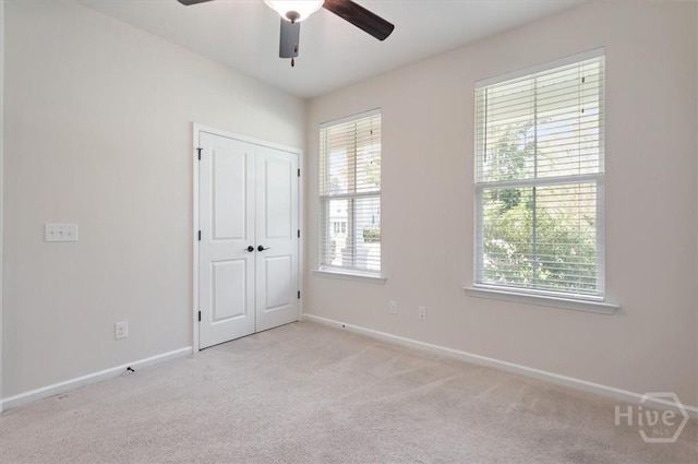 303 Waybridge Way, Richmond Hill, GA 31324 - unfurnished bedroom with light carpet, baseboards, a ceiling fan, and a closet