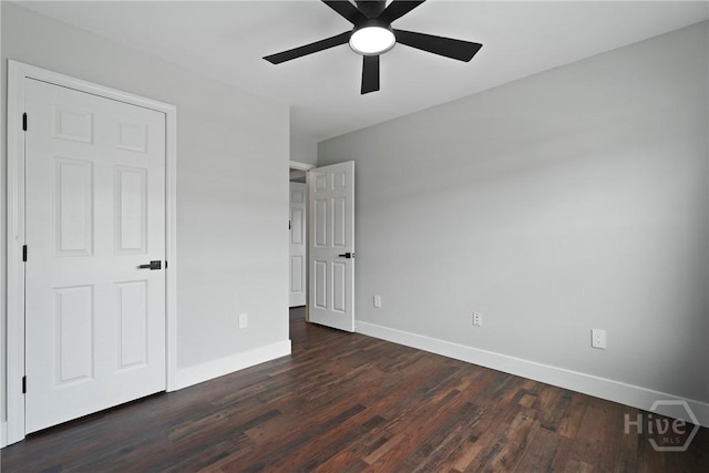 570 Canyon Oak Loop, Richmond Hill, GA 31324 - unfurnished bedroom with dark wood-style floors, baseboards, and ceiling fan