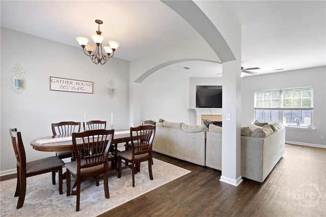 244 Murray Crossing Blvd NE, Ludowici, GA 31316 - dining space featuring dark wood finished floors, arched walkways, ceiling fan, baseboards, and a chandelier