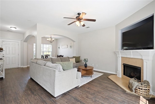 244 Murray Crossing Blvd NE, Ludowici, GA 31316 - living area featuring arched walkways, dark wood-style floors, ceiling fan, a chandelier, and a fireplace