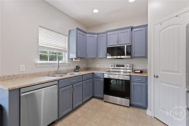 244 Murray Crossing Blvd NE, Ludowici, GA 31316 - kitchen with stainless steel appliances, a sink, light countertops, gray cabinetry, and recessed lighting