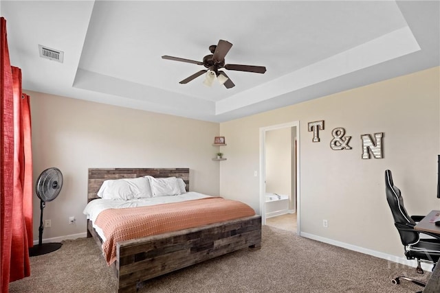 244 Murray Crossing Blvd NE, Ludowici, GA 31316 - bedroom with a tray ceiling, carpet flooring, baseboards, ensuite bathroom, and a ceiling fan