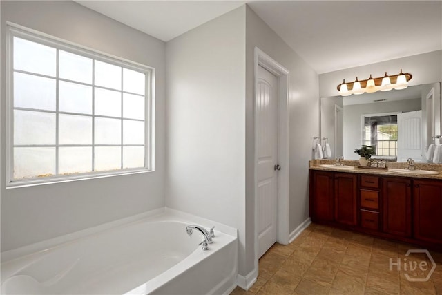 244 Murray Crossing Blvd NE, Ludowici, GA 31316 - bathroom featuring double vanity, a garden tub, and baseboards