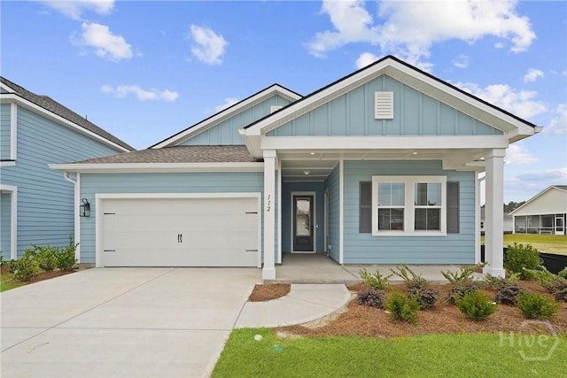 112 Mage St, Savannah, GA 31302 - view of front facade with board and batten siding, driveway, a garage, and a porch