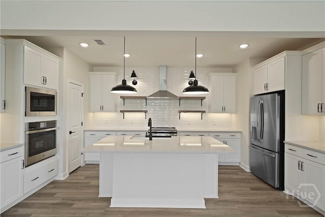 112 Mage St, Savannah, GA 31302 - kitchen featuring appliances with stainless steel finishes, wall chimney exhaust hood, dark wood finished floors, light countertops, and recessed lighting