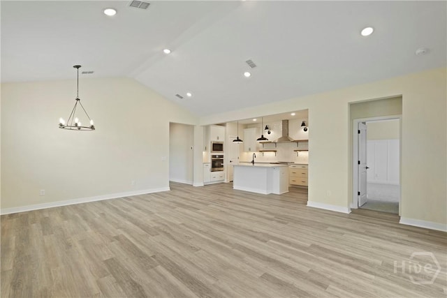112 Mage St, Savannah, GA 31302 - unfurnished living room with a chandelier, a sink, lofted ceiling, light wood-type flooring, and baseboards