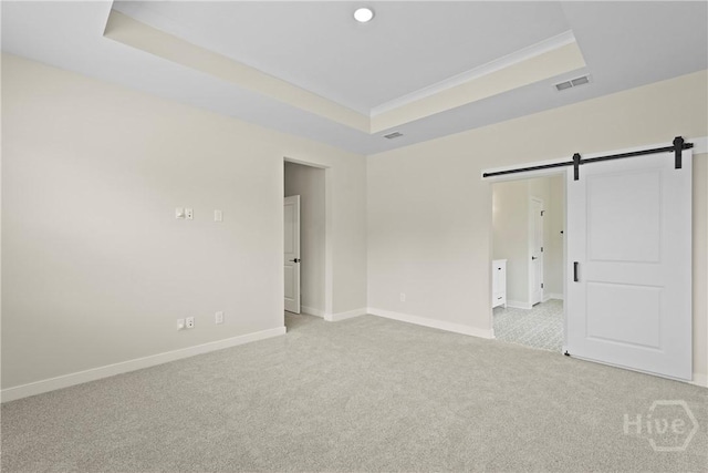 112 Mage St, Savannah, GA 31302 - unfurnished bedroom with carpet floors, a barn door, a tray ceiling, and baseboards